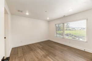 Unfurnished room featuring hardwood / wood-style floors and recessed lighting