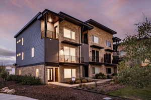 View of property at dusk