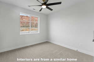 Unfurnished room with light carpet and a ceiling fan