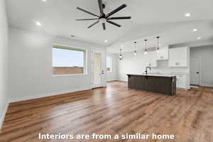 Unfurnished living room featuring recessed lighting, light wood finished floors, vaulted ceiling, and a ceiling fan