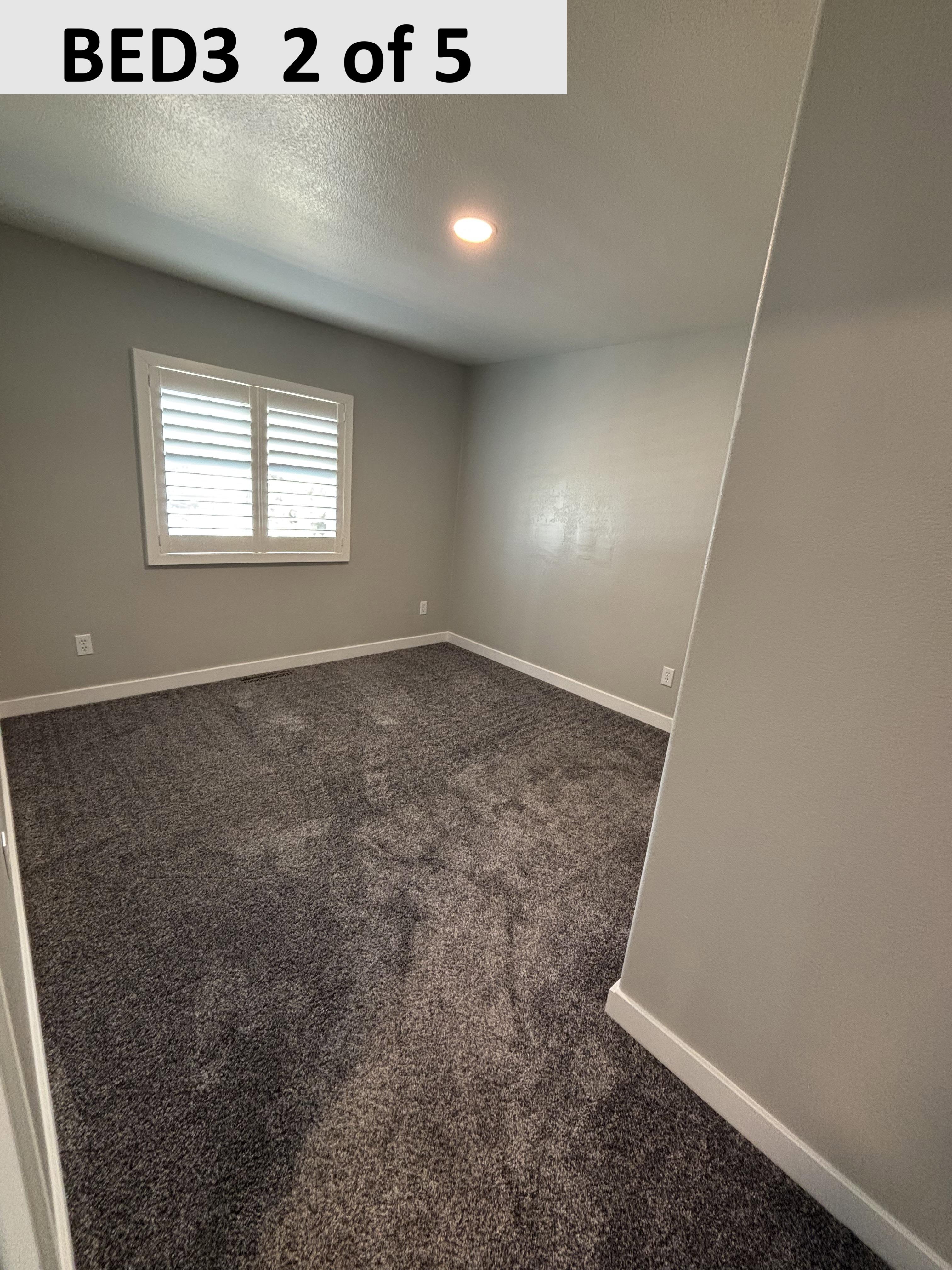 Bedroom 3 featuring dark carpet, a textured ceiling, and recessed lighting