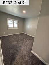Bedroom 3 featuring dark carpet, a textured ceiling, and recessed lighting