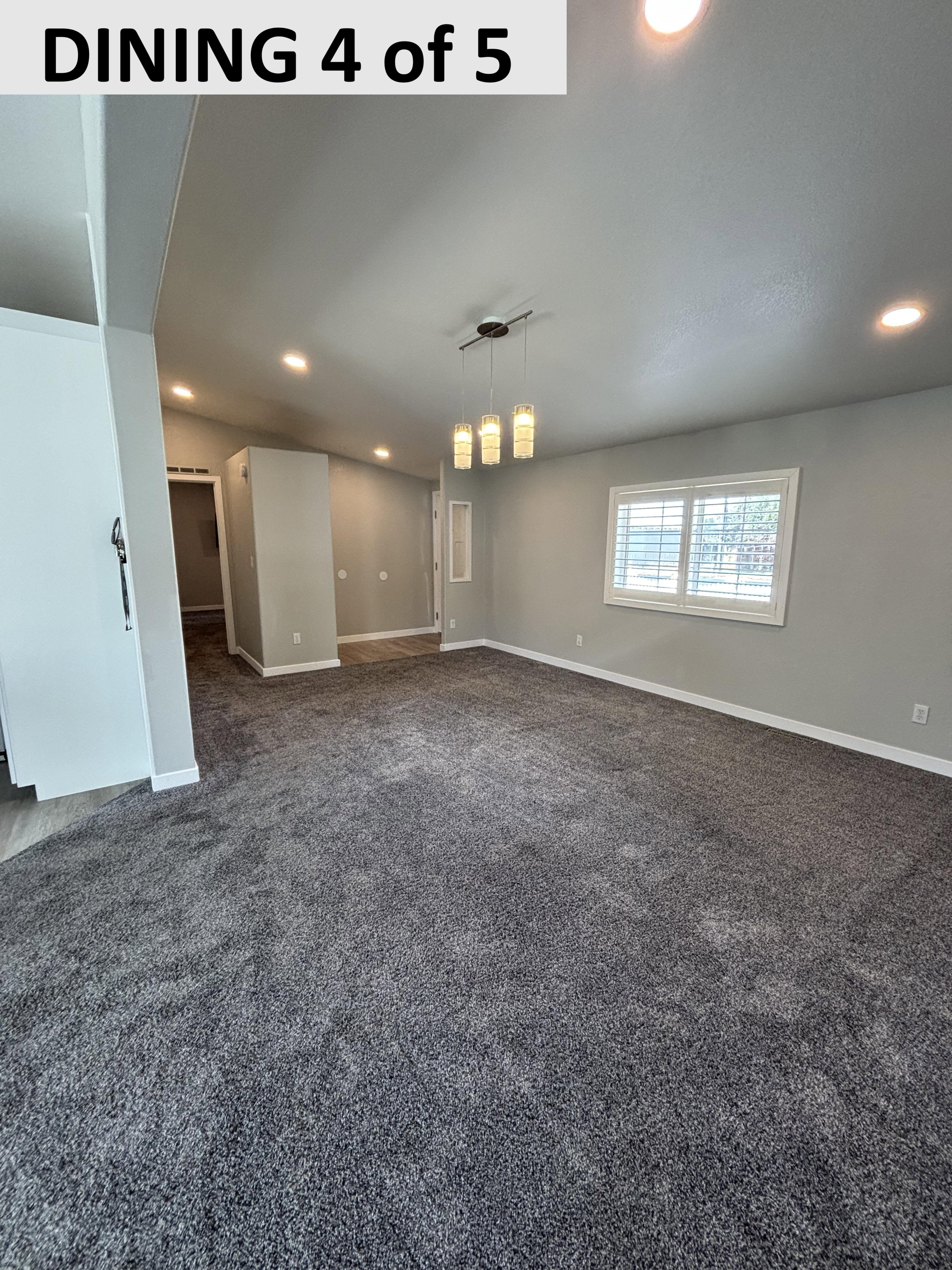 Empty room featuring recessed lighting and dark carpet