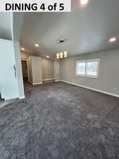 Empty room featuring recessed lighting and dark carpet