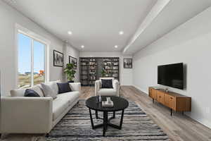 VIRTUALLY STAGED_Living room featuring recessed lighting and light wood-style floors