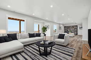 VIRTUALLY STAGED_Living area with recessed lighting and light wood finished floors