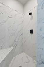 Full bathroom featuring a marble finish shower