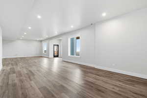 Unfurnished living room featuring recessed lighting and wood finished floors