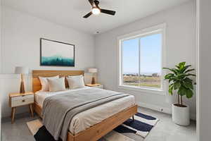 VIRTUALLY STAGED_Carpeted bedroom with a ceiling fan and baseboards