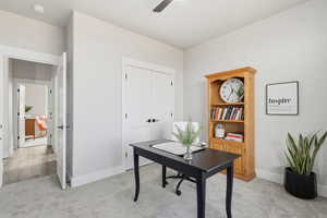 STAGED - Office space with light colored carpet and a ceiling fan