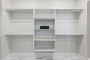 Master Bedroom_Spacious closet with light marble finish floors