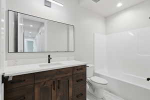 Bathroom with vanity, recessed lighting, and shower / bathtub combination