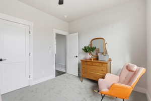 STAGED - Bedroom / Nursery_Sitting room featuring carpet floors and ceiling fan