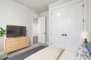 VIRTUALLY STAGED_Carpeted bedroom with baseboards and a closet