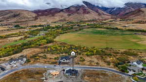 Drone / aerial view looking back to the east to Cherry Peak Ski Resort and Mountains