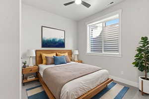 VIRTUAL STAGED_Bedroom featuring ceiling fan and light carpet