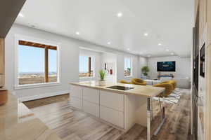 VIRTUAL STAGING: Kitchen featuring modern cabinets, open floor plan, recessed lighting, light wood-style flooring, and white cabinets