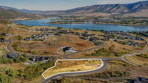 View of property location with a water and mountain view and nearby suburban area