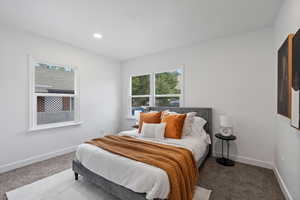Bedroom featuring carpet flooring, multiple windows, and recessed lighting