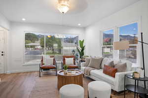 Living area with wood finished floors, a mountain view, and recessed lighting