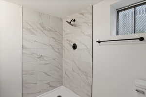 Bathroom with tiled shower and toilet