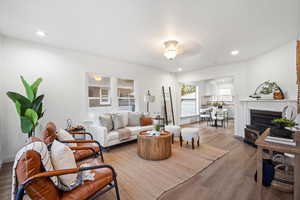 Living area featuring wood finished floors, a fireplace, and recessed lighting