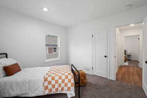 Carpeted bedroom featuring recessed lighting and baseboards
