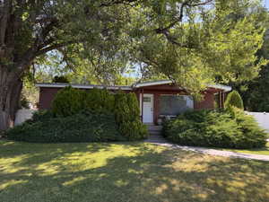 Mid-century home featuring brick siding