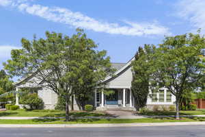 View of front facade with a porch and a front lawn