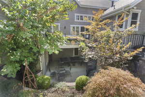 Back of house with a shingled roof and a balcony