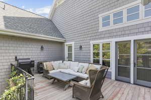 Deck featuring outdoor lounge area and area for grilling