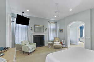 Bedroom featuring arched walkways, carpet, a fireplace, recessed lighting, and ceiling fan