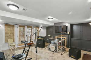 Workout room with wood finished floors and baseboards