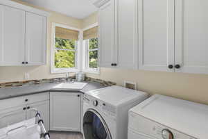 Laundry room with cabinet space and washing machine and clothes dryer