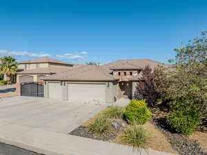 View of front of house featuring stucco siding, a garage, and concrete driveway