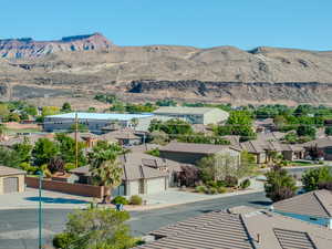 View of mountain backdrop featuring nearby suburban area