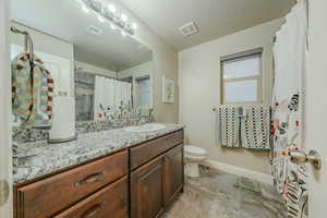 Full bath with vanity and a shower with shower curtain