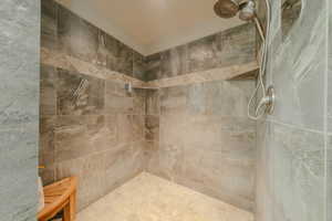 Full bath featuring tiled shower