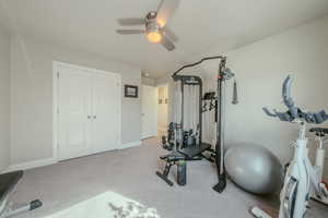 Workout room with carpet flooring and a ceiling fan