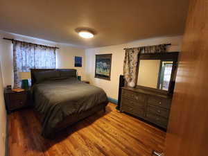 Bedroom featuring light wood-style floors and baseboards