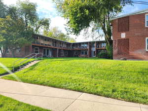 View of home's community featuring a lawn and stairway