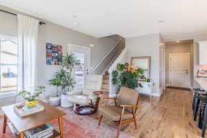 Living area featuring light wood-type flooring and stairway