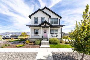 View of front facade featuring board and batten siding, a porch, and a mountain view