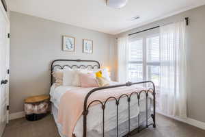 Carpeted bedroom with baseboards