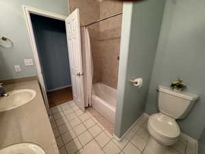 Full bathroom featuring light tile patterned floors, shower / tub combo, and vanity