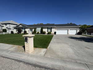 Ranch-style house with concrete driveway and a garage