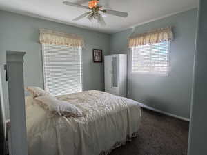 Carpeted bedroom featuring baseboards and a ceiling fan