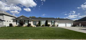 Ranch-style house featuring brick siding, concrete driveway, and an attached garage