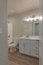 Full bath with vanity,  shower combination, and dark wood-style floors