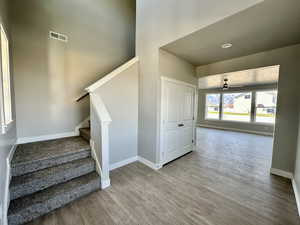 Staircase featuring baseboards and wood finished floors